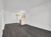 Thumbnail 17 of 48 - A room with a white wall and a wooden floor.