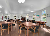 Thumbnail 10 of 48 - A room with wooden tables and chairs and a white ceiling.