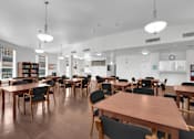 Thumbnail 9 of 48 - A room with tables and chairs and a white ceiling.