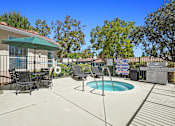 Thumbnail 3 of 48 - A patio with a table and chairs and a pool.
