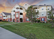 Thumbnail 3 of 33 - A large apartment complex with multiple buildings and balconies.