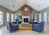 Thumbnail 14 of 33 - A living room with a fireplace and a couch.