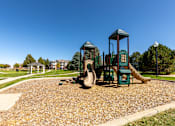 Thumbnail 10 of 33 - A playground with a green slide and a yellow slide.