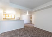 Thumbnail 28 of 33 - A large, empty room with a carpeted floor and white walls.