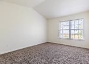 Thumbnail 30 of 33 - A room with a carpeted floor and a window.