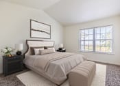 Thumbnail 16 of 33 - A bedroom with a large bed and a window.