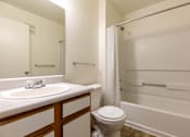 Thumbnail 33 of 33 - A white bathroom with a toilet, sink, and bathtub.