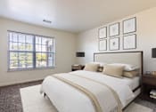 Thumbnail 20 of 33 - A bedroom with a large bed and a window overlooking a tree-filled area.