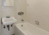 Thumbnail 15 of 15 - a white bathroom with a sink and a tub