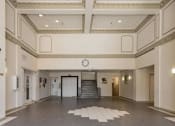 Thumbnail 3 of 15 - a large room with a clock on the wall and a staircase