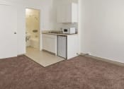 Thumbnail 9 of 15 - an empty kitchen with a microwave and a sink