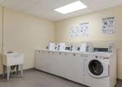 Thumbnail 7 of 15 - a washer and dryer in the laundry room of a building