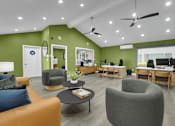 Thumbnail 72 of 73 - A living room with a green wall and a couch.