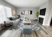 Thumbnail 27 of 39 - a living room with gray walls and a gray and white rug