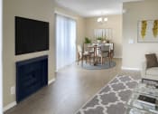 Thumbnail 22 of 39 - a living room with a fireplace and a dining room table with chairs