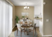 Thumbnail 23 of 39 - a dining room with a table and chairs and a kitchen in the background