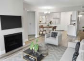 Thumbnail 13 of 39 - a living room with a fireplace and a kitchen in the background