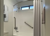 Thumbnail 11 of 39 - a bathroom with a toilet and a tub and a shower curtain
