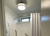 Thumbnail 10 of 39 - a bathroom with a shower and a toilet and a curtain