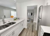 Thumbnail 30 of 39 - a kitchen with white cabinets and stainless steel appliances