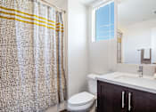 Thumbnail 10 of 28 - The Harrington bathroom vanity, toilet, and shower with window