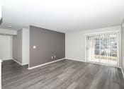 Thumbnail 16 of 35 - an empty living room with wood flooring and a window