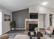 Thumbnail 3 of 14 - a living room with a fireplace and a tv on the wall