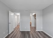 Thumbnail 12 of 14 - the living room of an apartment with white walls and wood flooring
