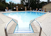Thumbnail 14 of 14 - A pool with a metal ladder leading into the water.