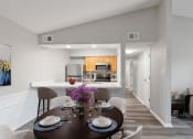 Thumbnail 5 of 14 - a dining room and kitchen area with a table and chairs