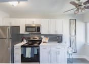 Thumbnail 3 of 24 - a kitchen with white cabinets and stainless steel appliances