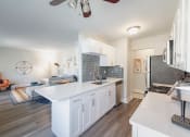 Thumbnail 6 of 24 - a kitchen with a white counter top and a stainless steel refrigerator