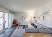 Thumbnail 7 of 24 - a living room with a couch and a coffee table