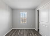 Thumbnail 10 of 14 - an empty living room with wood flooring and a window