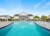 Thumbnail 1 of 24 - a large swimming pool with a building in the background