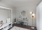 Thumbnail 13 of 35 - a bedroom with a vanity and a mirror