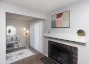 Thumbnail 11 of 35 - a living room with a fireplace and a desk