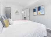 Thumbnail 14 of 35 - a bedroom with a large bed and two paintings on the wall