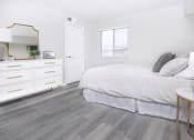 Thumbnail 15 of 35 - a bedroom with a bed and a dresser and a mirror