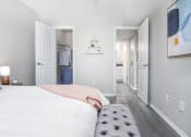 Thumbnail 12 of 35 - a bedroom with a bed and a closet      and a hallway