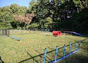 Thumbnail 33 of 35 - A playground with a blue fence and a red slide.