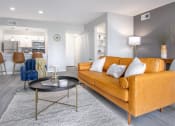 Thumbnail 4 of 35 - a living room with an orange couch and a table