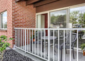 Thumbnail 38 of 39 - Harrisburg Apartment | Twin Lakes Apartments | a balcony with two chairs and a table
