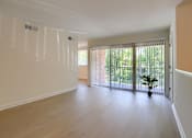 Thumbnail 11 of 39 - A room with a sliding glass door leading to a balcony.