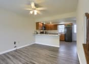 Thumbnail 32 of 51 - Mechanicsburg Apartments | Rockledge Townhomes |an empty living room with a kitchen in the background