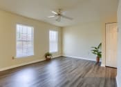Thumbnail 43 of 51 - Mechanicsburg Apartments | Rockledge Townhomes |  an empty living room with a ceiling fan and two windows