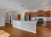 Thumbnail 3 of 37 - a kitchen with a large center island with a white countertop | Centerpointe Apartments in Camp Hill