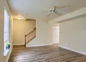 Thumbnail 50 of 58 - A room with a wooden floor and a ceiling fan.