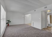 Thumbnail 26 of 26 - Apartments in Williamsport | Woodland Park | a bedroom with a large window and a carpeted floor