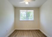 Thumbnail 30 of 39 - A room with a window and a ceiling fan.